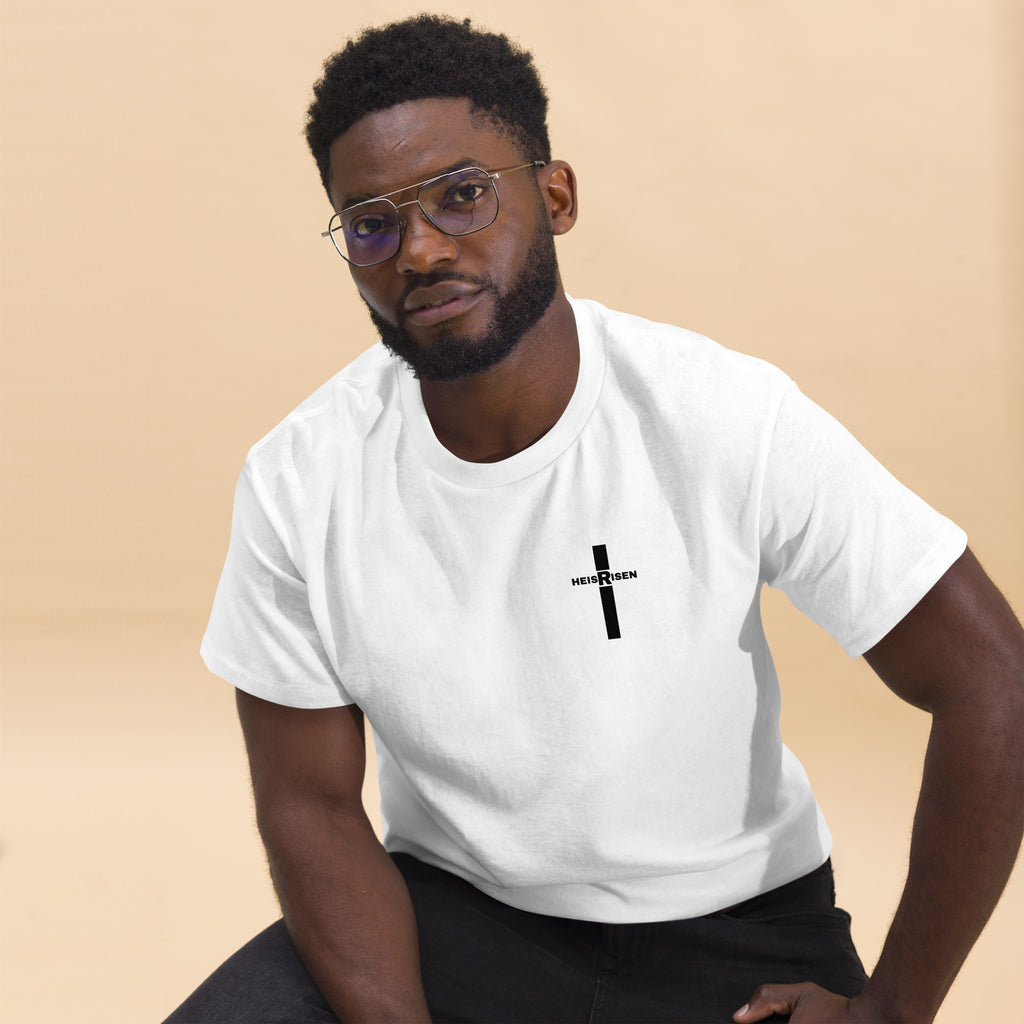 Christian Easter T‑shirt with “HE IS RISEN” design, inspired by 1 Peter 1:3 and celebrating the daily reality of Christ’s resurrection.