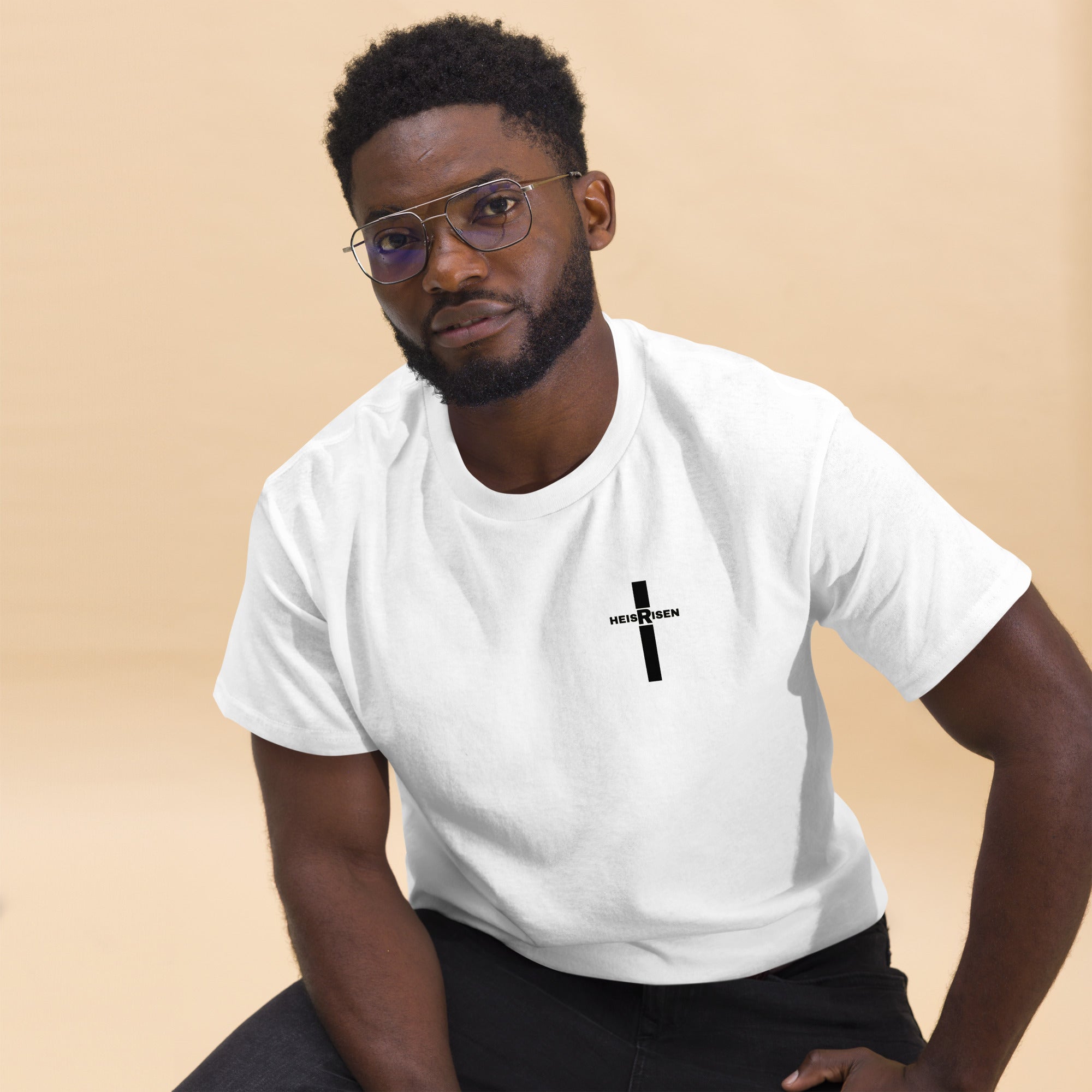 Christian Easter T‑shirt with “HE IS RISEN” design, inspired by 1 Peter 1:3 and celebrating the daily reality of Christ’s resurrection.