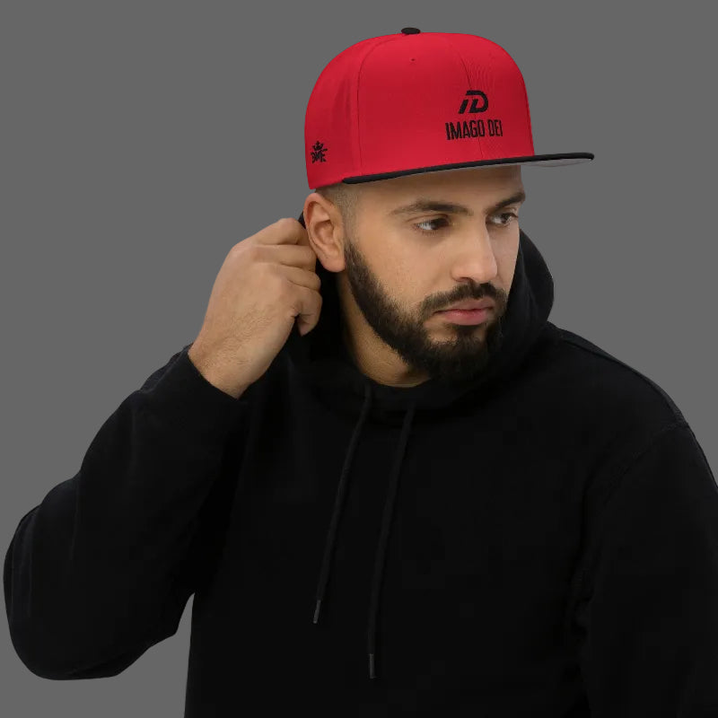 Black and red IMAGO DEI snapback hat with red embroidery — Christian streetwear.